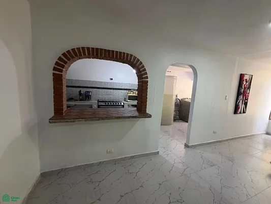 Open kitchen with white cabinets